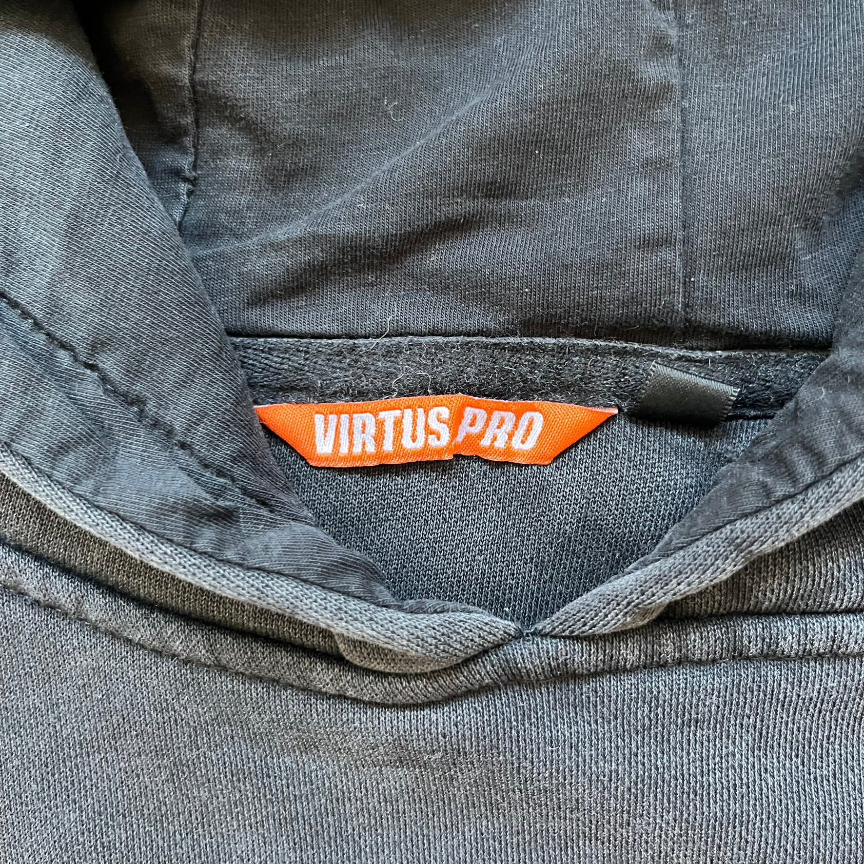 Virtus Pro 2020s Washed Black Hoodie is a black pullover hoodie featuring the Virtus.Pro logo on the front. Made from soft, high-quality materials, it offers a comfortable fit with durability suitable for casual wear or gaming. This hoodie was released in the 2020s as official Virtus.Pro esports merchandise.