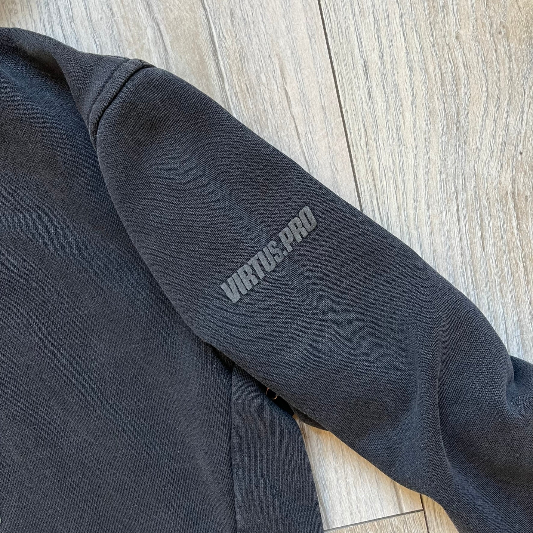 Virtus Pro 2020s Washed Black Hoodie is a black pullover hoodie featuring the Virtus.Pro logo on the front. Made from soft, high-quality materials, it offers a comfortable fit with durability suitable for casual wear or gaming. This hoodie was released in the 2020s as official Virtus.Pro esports merchandise.