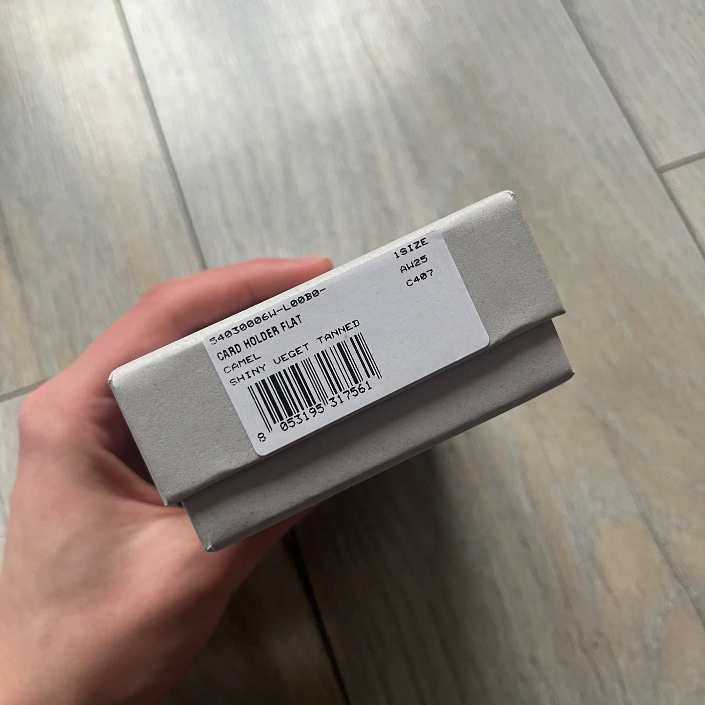 Vivienne Westwood Brown Flat Card Holder is crafted from buffed leather in a camel brown tone with logo hardware at the front. It features four card slots, a central note compartment, black twill lining, and an interior leather Vivienne Westwood tab with a material tag. Made in Italy, the card holder comes with the original box and tags. 252314M163098