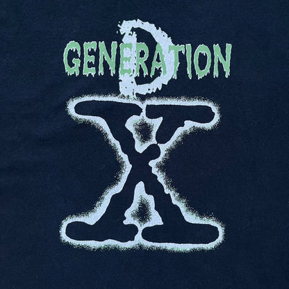 WWE D-Generation X 2000s Black Tee is a black short-sleeve T-shirt made on a Gildan blank in the early 2000s. The front features a D-Generation X logo with a large black “X” outlined in white glow and subtle green, topped with white “D” and green “Generation” text. This shirt was released as official WWE merchandise during the 2000s.