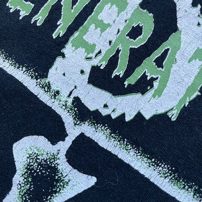 WWE D-Generation X 2000s Black Tee is a black short-sleeve T-shirt made on a Gildan blank in the early 2000s. The front features a D-Generation X logo with a large black “X” outlined in white glow and subtle green, topped with white “D” and green “Generation” text. This shirt was released as official WWE merchandise during the 2000s.
