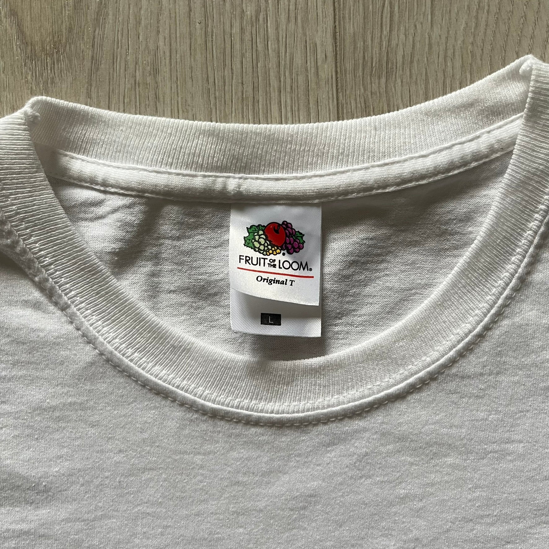 Vintage WWE Superstars Tee in white, highlighted by a large front print of wrestling icons The Rock, Rey Mysterio, and John Cena over a yellow base. Features the WWE logo and “Superstars” branding, printed on a Fruit of the Loom blank.