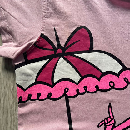 Baby pink 2013 Wacky Races women’s tee with Penelope Pitstop and her iconic "The Compact Pussycat" car. Glittery pink accents on her helmet, skirt, umbrella with white “Penelope Pitstop!” text. Officially Hanna-Barbera licensed.