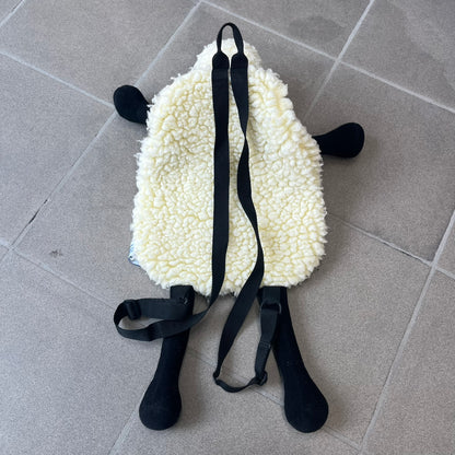 Wallace &amp; Gromit “Shaun The Sheep” 1990’s Backpack is a character-shaped backpack designed as Shaun the Sheep with black shoulder straps running from the bottom to the top of the body. The arms, legs, and ears are movable, and the face features plastic eyes. It includes one large main storage compartment, dating to the late 1980s-1990s production period.
