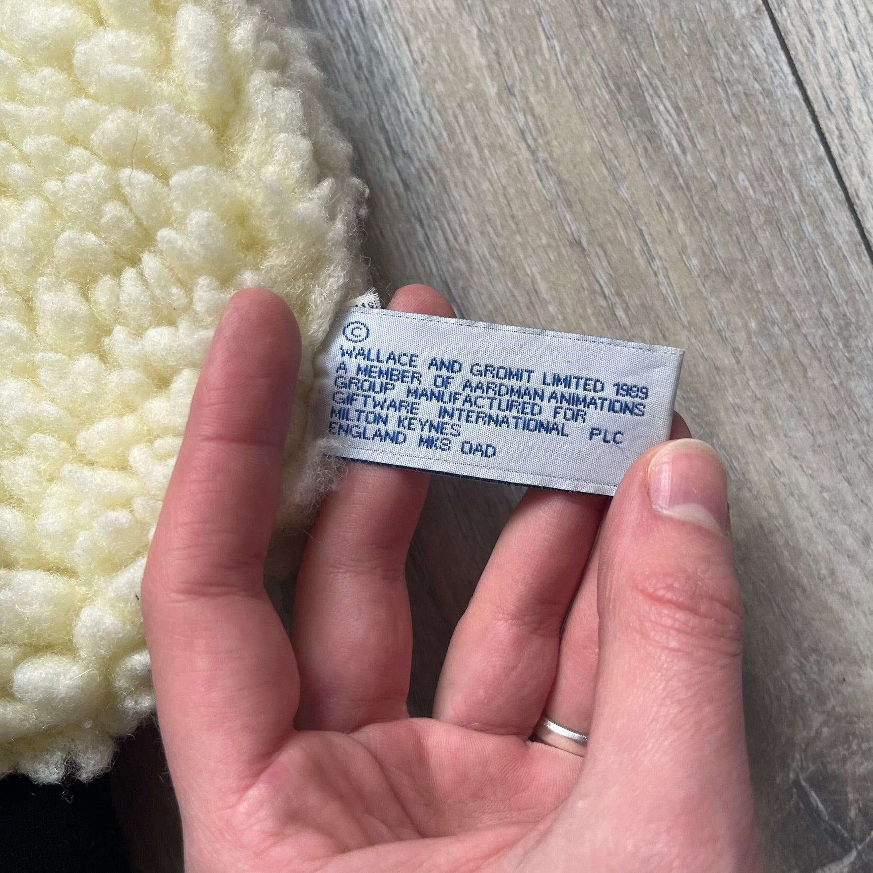 Wallace &amp; Gromit “Shaun The Sheep” 1990’s Backpack is a character-shaped backpack designed as Shaun the Sheep with black shoulder straps running from the bottom to the top of the body. The arms, legs, and ears are movable, and the face features plastic eyes. It includes a Wallace &amp; Gromit paper tag, a material tag, and one large main storage compartment, dating to the late 1980s-1990s production period.