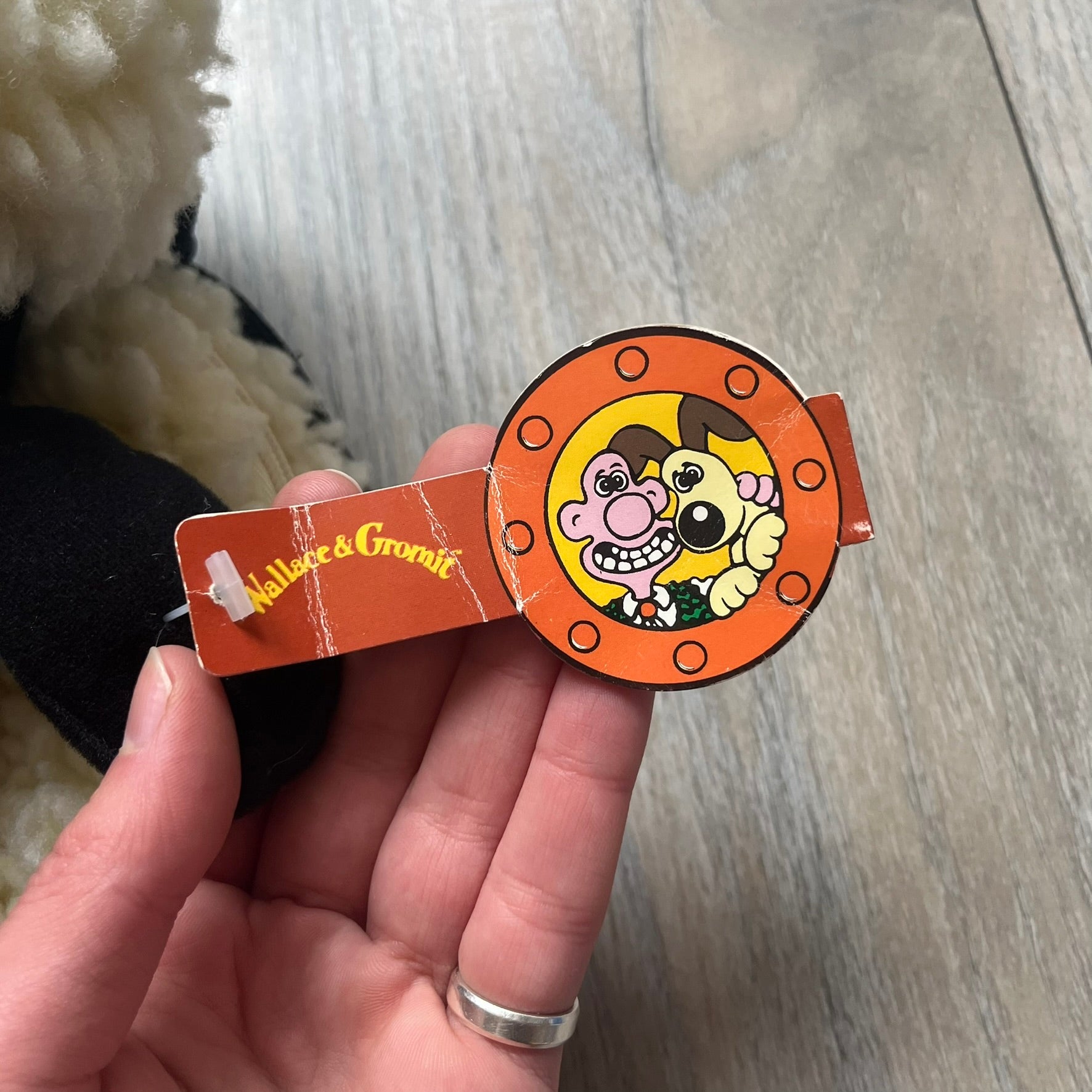 Wallace &amp; Gromit “Shaun The Sheep” 1990’s Backpack is a character-shaped backpack designed as Shaun the Sheep with black shoulder straps running from the bottom to the top of the body. The arms, legs, and ears are movable, and the face features plastic eyes. It includes a Wallace &amp; Gromit paper tag, a material tag, and one large main storage compartment, dating to the late 1980s-1990s production period.