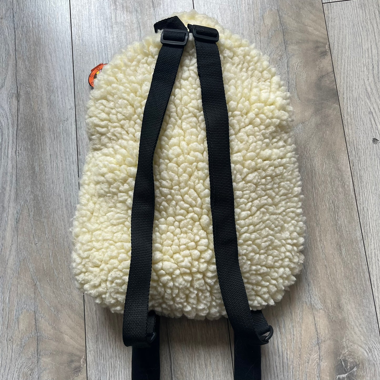 Wallace &amp; Gromit “Shaun The Sheep” 1990’s Backpack is a character-shaped backpack designed as Shaun the Sheep with black shoulder straps running from the bottom to the top of the body. The arms, legs, and ears are movable, and the face features plastic eyes. It includes a Wallace &amp; Gromit paper tag, a material tag, and one large main storage compartment, dating to the late 1980s-1990s production period.