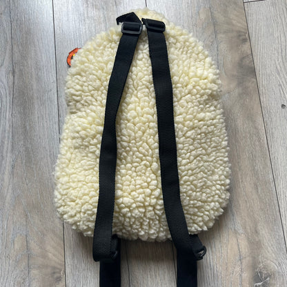 Wallace &amp; Gromit “Shaun The Sheep” 1990’s Backpack is a character-shaped backpack designed as Shaun the Sheep with black shoulder straps running from the bottom to the top of the body. The arms, legs, and ears are movable, and the face features plastic eyes. It includes a Wallace &amp; Gromit paper tag, a material tag, and one large main storage compartment, dating to the late 1980s-1990s production period.