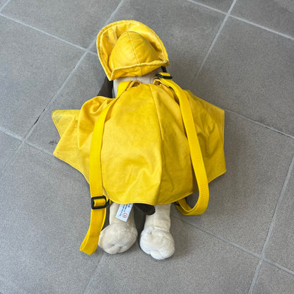 The Wallace and Gromit Gromit Plush Backpack is a 1990s licensed item produced by Aardman Animations. It features Gromit dressed in his bright yellow PVC raincoat and matching hat, as seen in The Wrong Trousers. The backpack is made from soft plush fabric with plastic eyes, a hard black nose, and a genuine stamp confirming official production. The bag opens from the side and includes adjustable shoulder straps for wearability.