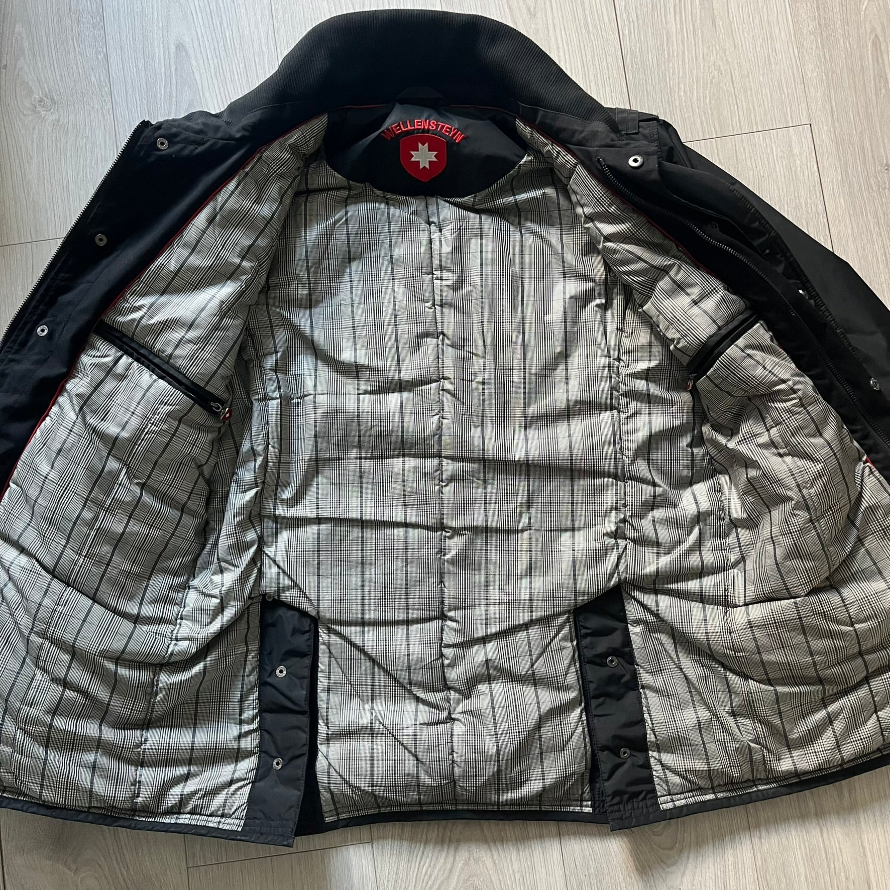 The Wellensteyn Mercury Black Winter Jacket combines premium function with tailored elegance. Crafted from TiSaAirTec fabric, it offers a smooth, matte finish that is waterproof, windproof, and built for temperatures from 0 to -20 °C. Features include a removable inner jacket with a high knit collar, multiple secure pockets, back vents, and a quilted lining for warmth. A signature of German engineering and timeless outerwear design.