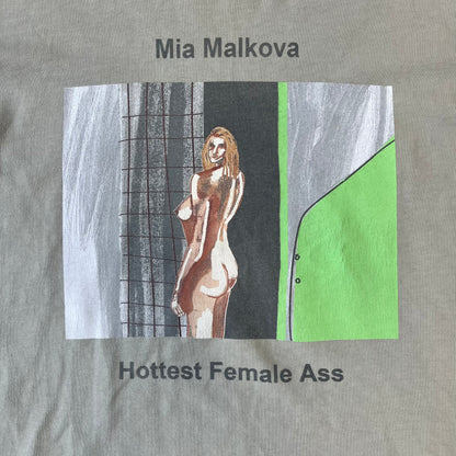 Longsleeve tee from the FW18 Yeezy x Pornhub collection, released 09/07/2018. Vapor color, featuring a front illustration of painted Mia Malkova with her name above and “Hottest Female Ass” below. Back has the numbers “6918” (futuristic theme set in the year 6918). Includes printed Pornhub tag and YEEZY wash tag, part of a limited run commemorating the 2018 Pornhub Awards.