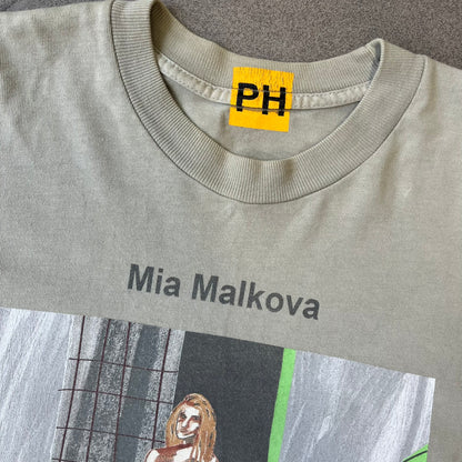 Longsleeve tee from the FW18 Yeezy x Pornhub collection, released 09/07/2018. Vapor color, featuring a front illustration of painted Mia Malkova with her name above and “Hottest Female Ass” below. Back has the numbers “6918” (futuristic theme set in the year 6918). Includes printed Pornhub tag and YEEZY wash tag, part of a limited run commemorating the 2018 Pornhub Awards.