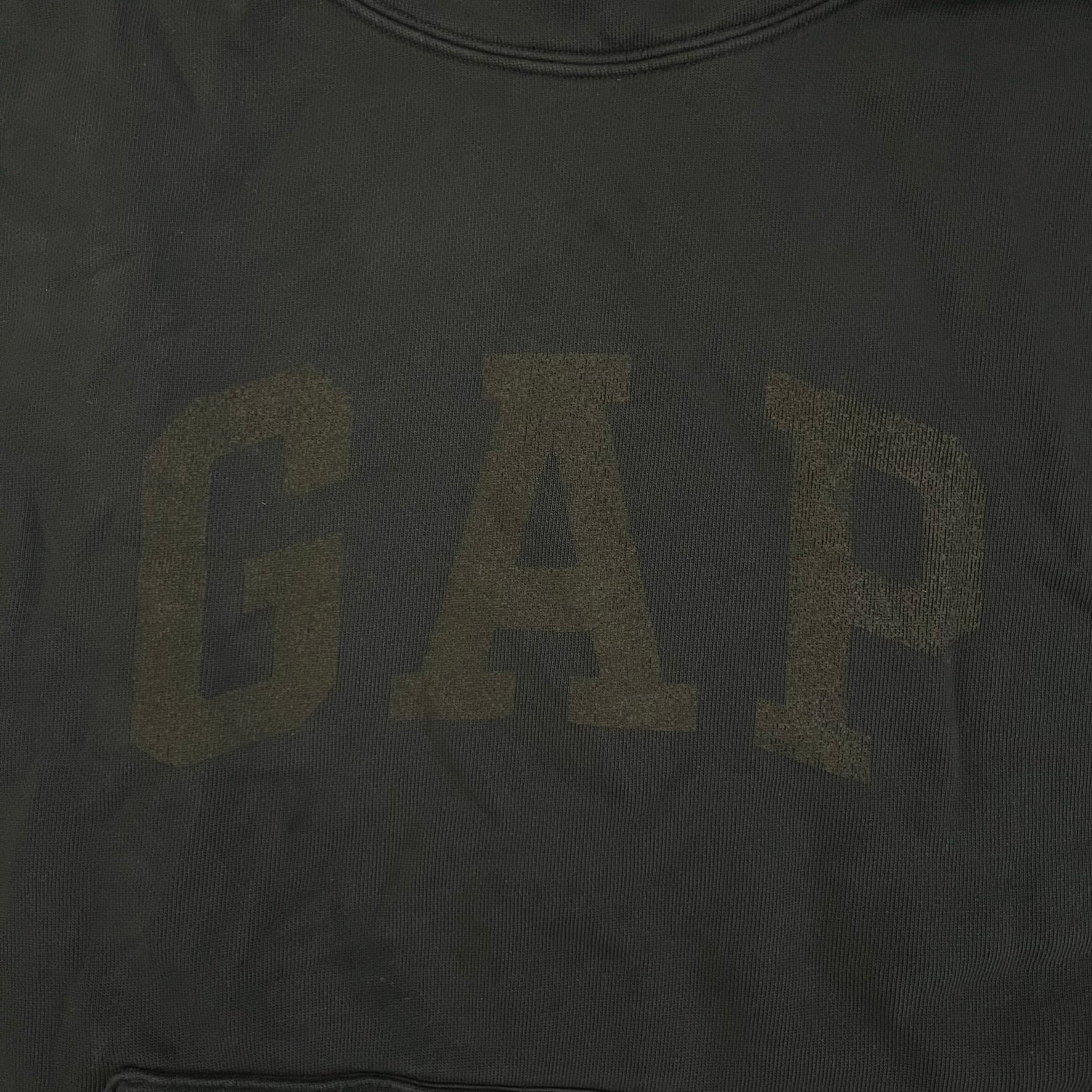 Yeezy GAP Engineered by Balenciaga Dove Hoodie in washed black, produced as part of the three-way Yeezy, GAP, and Balenciaga collaboration. Features a boxy, oversized fit with a slightly darker oversized GAP logo printed on the front and a large white dove graphic on the back. Each hoodie shows natural variation in wash, tone, and texture, consistent with the production process used for this release, from LosAngelesArchive.