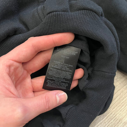 Yeezy GAP Engineered by Balenciaga Dove Hoodie in washed black, produced as part of the three-way Yeezy, GAP, and Balenciaga collaboration. Features a boxy, oversized fit with a slightly darker oversized GAP logo printed on the front and a large white dove graphic on the back. Each hoodie shows natural variation in wash, tone, and texture, consistent with the production process used for this release, from LosAngelesArchive.