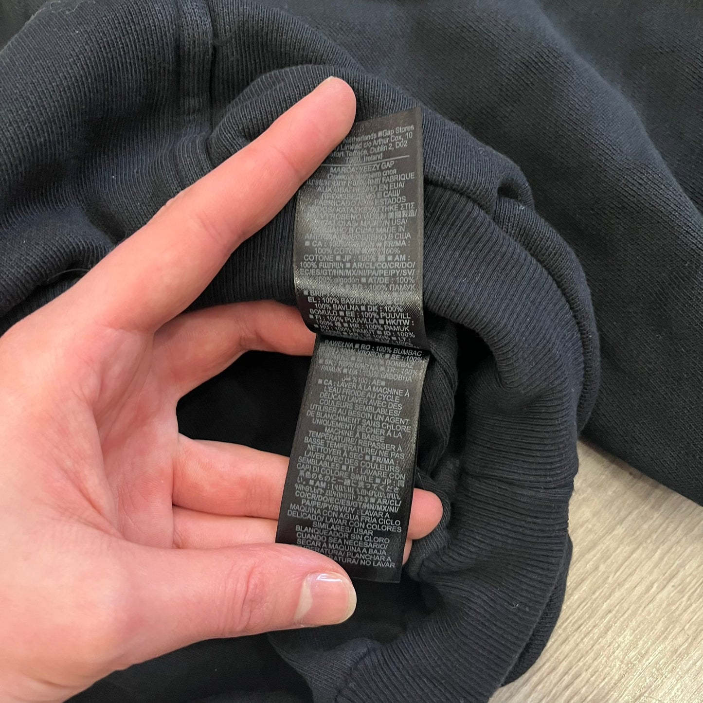 Yeezy GAP Engineered by Balenciaga Dove Hoodie in washed black, produced as part of the three-way Yeezy, GAP, and Balenciaga collaboration. Features a boxy, oversized fit with a slightly darker oversized GAP logo printed on the front and a large white dove graphic on the back. Each hoodie shows natural variation in wash, tone, and texture, consistent with the production process used for this release, from LosAngelesArchive.