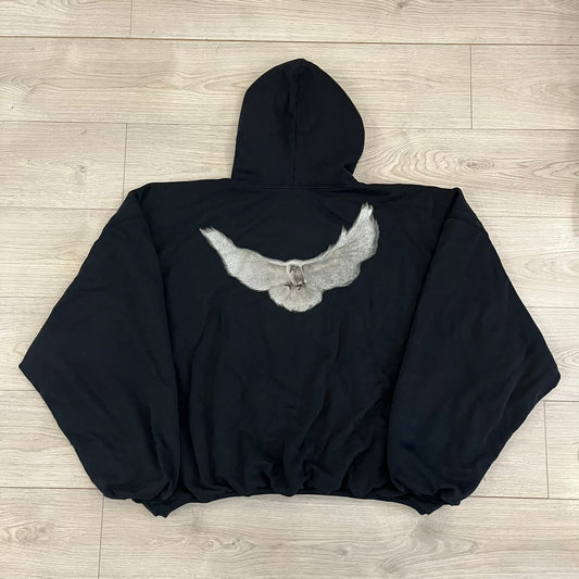 Yeezy GAP Engineered by Balenciaga Dove Hoodie in washed black, produced as part of the three-way Yeezy, GAP, and Balenciaga collaboration. Features a boxy, oversized fit with a slightly darker oversized GAP logo printed on the front and a large white dove graphic on the back. Each hoodie shows natural variation in wash, tone, and texture, consistent with the production process used for this release, from LosAngelesArchive.