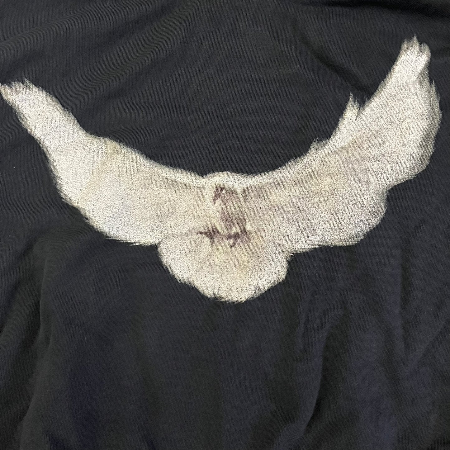 Yeezy GAP Engineered by Balenciaga Dove Hoodie in washed black, produced as part of the three-way Yeezy, GAP, and Balenciaga collaboration. Features a boxy, oversized fit with a slightly darker oversized GAP logo printed on the front and a large white dove graphic on the back. Each hoodie shows natural variation in wash, tone, and texture, consistent with the production process used for this release, from LosAngelesArchive.