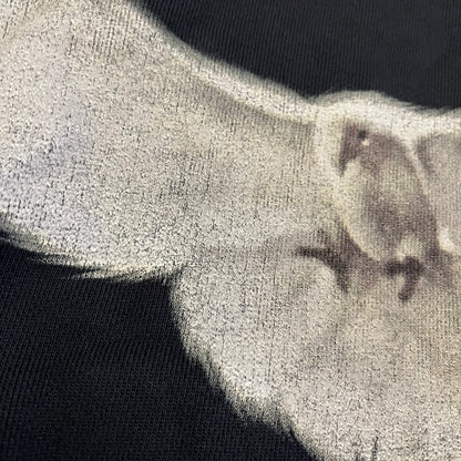 Yeezy GAP Engineered by Balenciaga Dove Hoodie in washed black, produced as part of the three-way Yeezy, GAP, and Balenciaga collaboration. Features a boxy, oversized fit with a slightly darker oversized GAP logo printed on the front and a large white dove graphic on the back. Each hoodie shows natural variation in wash, tone, and texture, consistent with the production process used for this release, from LosAngelesArchive.