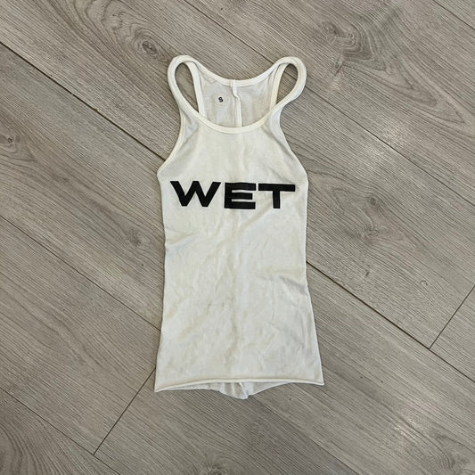 Yeezy x Mowalola WET Tank Top in white cotton with the big black “WET” graphic across the chest. The fabric is highly stretchy, giving it a flexible and sculpted fit.