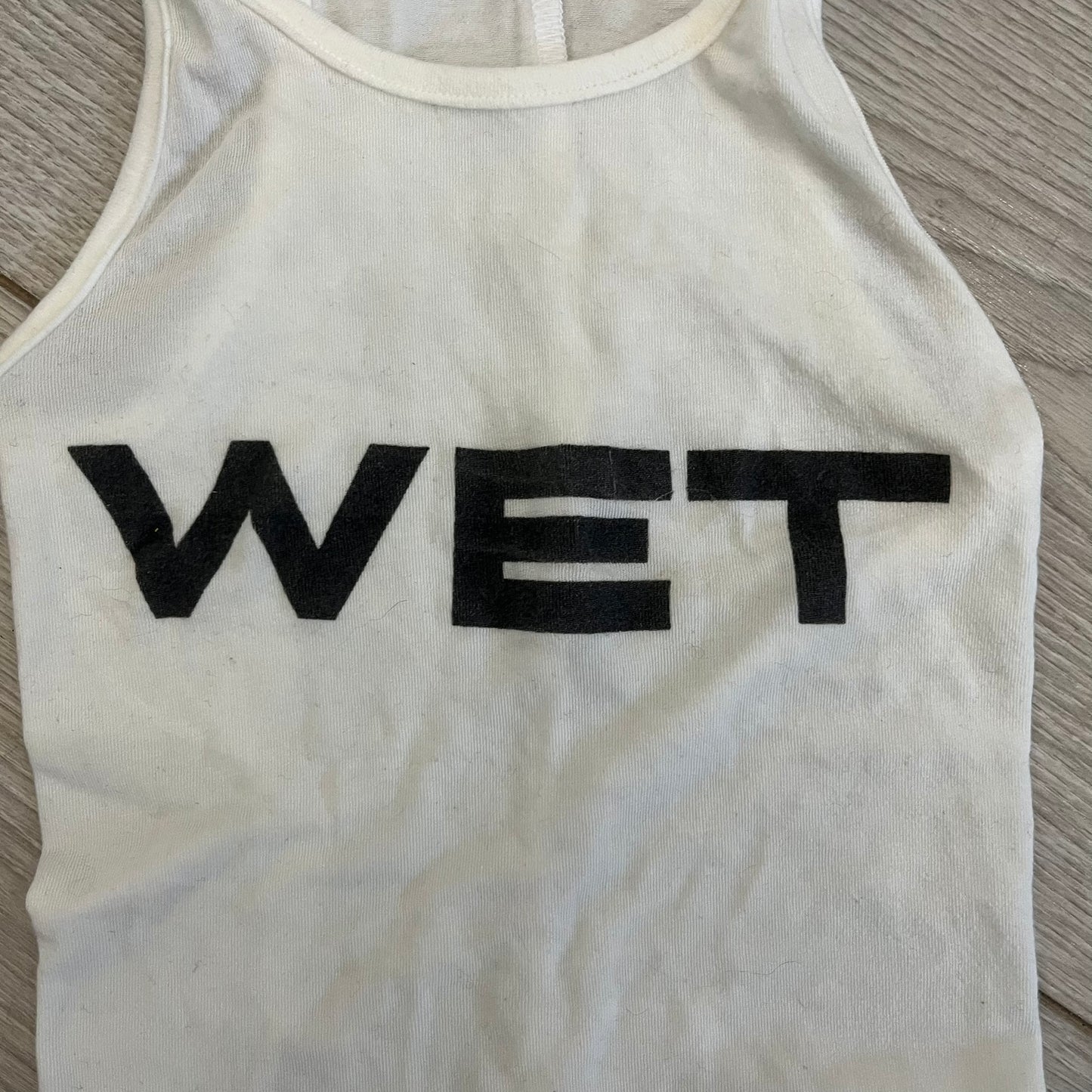 Yeezy x Mowalola WET Tank Top in white cotton with the big black “WET” graphic across the chest. The fabric is highly stretchy, giving it a flexible and sculpted fit.