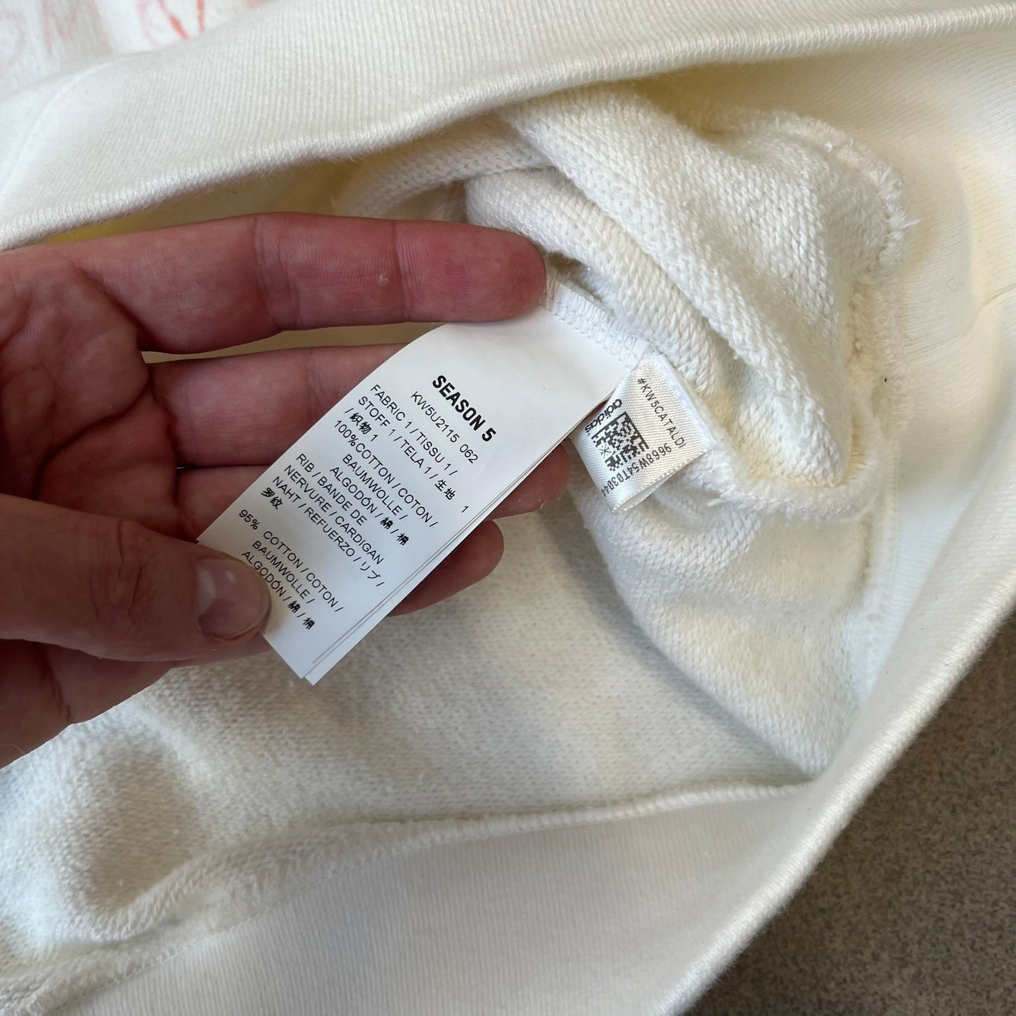 Yeezy Season 5 Scribbled Adidas Crewneck by ERD features an oversized, boxy silhouette in the Arctic colorway. The 100% cotton Adidas crewneck has handwritten-style printed graphics and phrases across the garment, including a embroidered Adidas Three Stripes logo on the chest. It was made in Italy and designed by Henri Alexander Levy from Enfants Riches Déprimés.