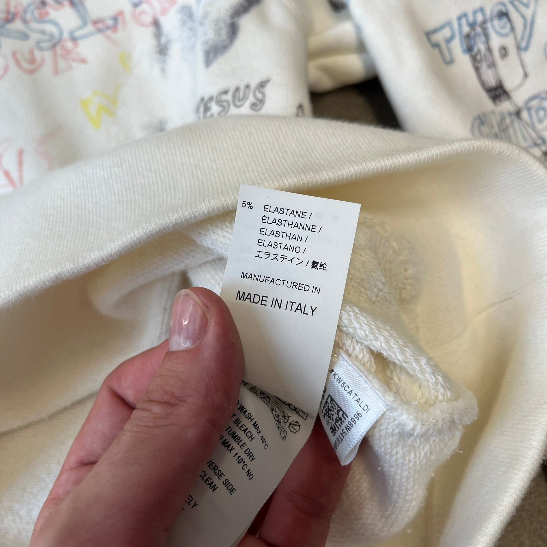 Yeezy Season 5 Scribbled Adidas Crewneck by ERD features an oversized, boxy silhouette in the Arctic colorway. The 100% cotton Adidas crewneck has handwritten-style printed graphics and phrases across the garment, including a embroidered Adidas Three Stripes logo on the chest. It was made in Italy and designed by Henri Alexander Levy from Enfants Riches Déprimés.