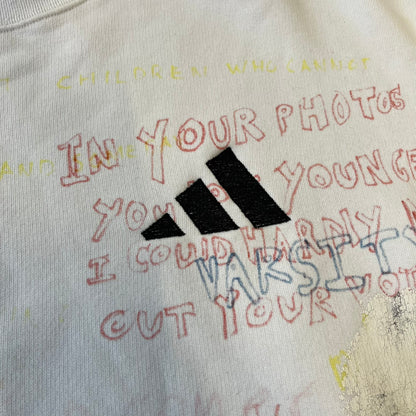 Yeezy Season 5 Scribbled Adidas Crewneck by ERD features an oversized, boxy silhouette in the Arctic colorway. The 100% cotton Adidas crewneck has handwritten-style printed graphics and phrases across the garment, including a embroidered Adidas Three Stripes logo on the chest. It was made in Italy and designed by Henri Alexander Levy from Enfants Riches Déprimés.