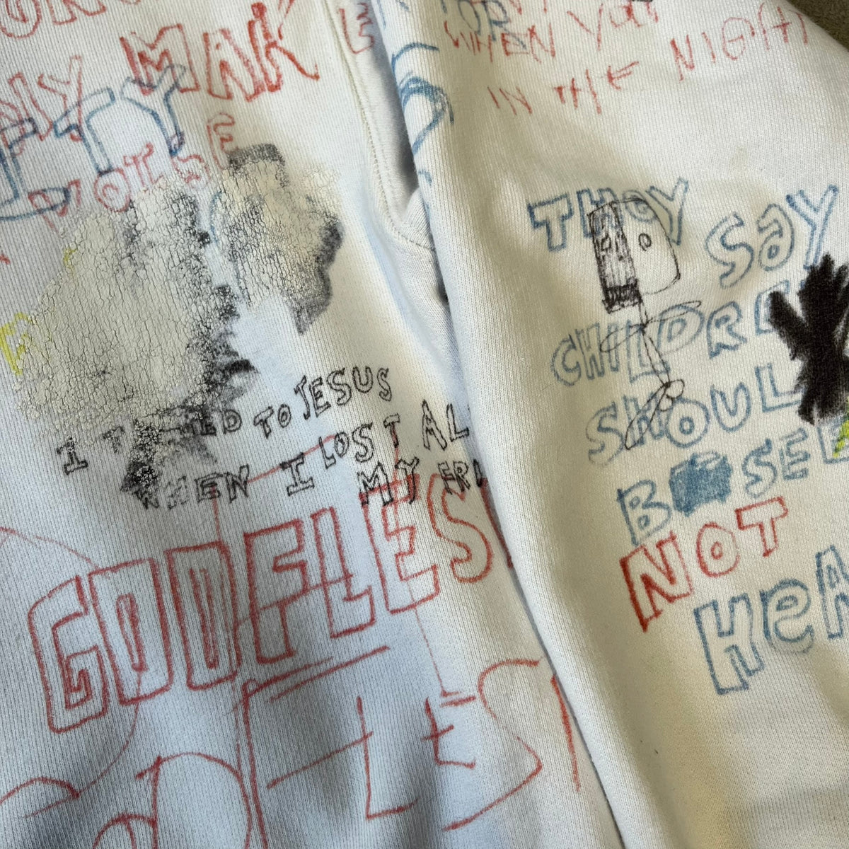 Yeezy Season 5 Scribbled Adidas Crewneck by ERD features an oversized, boxy silhouette in the Arctic colorway. The 100% cotton Adidas crewneck has handwritten-style printed graphics and phrases across the garment, including a embroidered Adidas Three Stripes logo on the chest. It was made in Italy and designed by Henri Alexander Levy from Enfants Riches Déprimés.