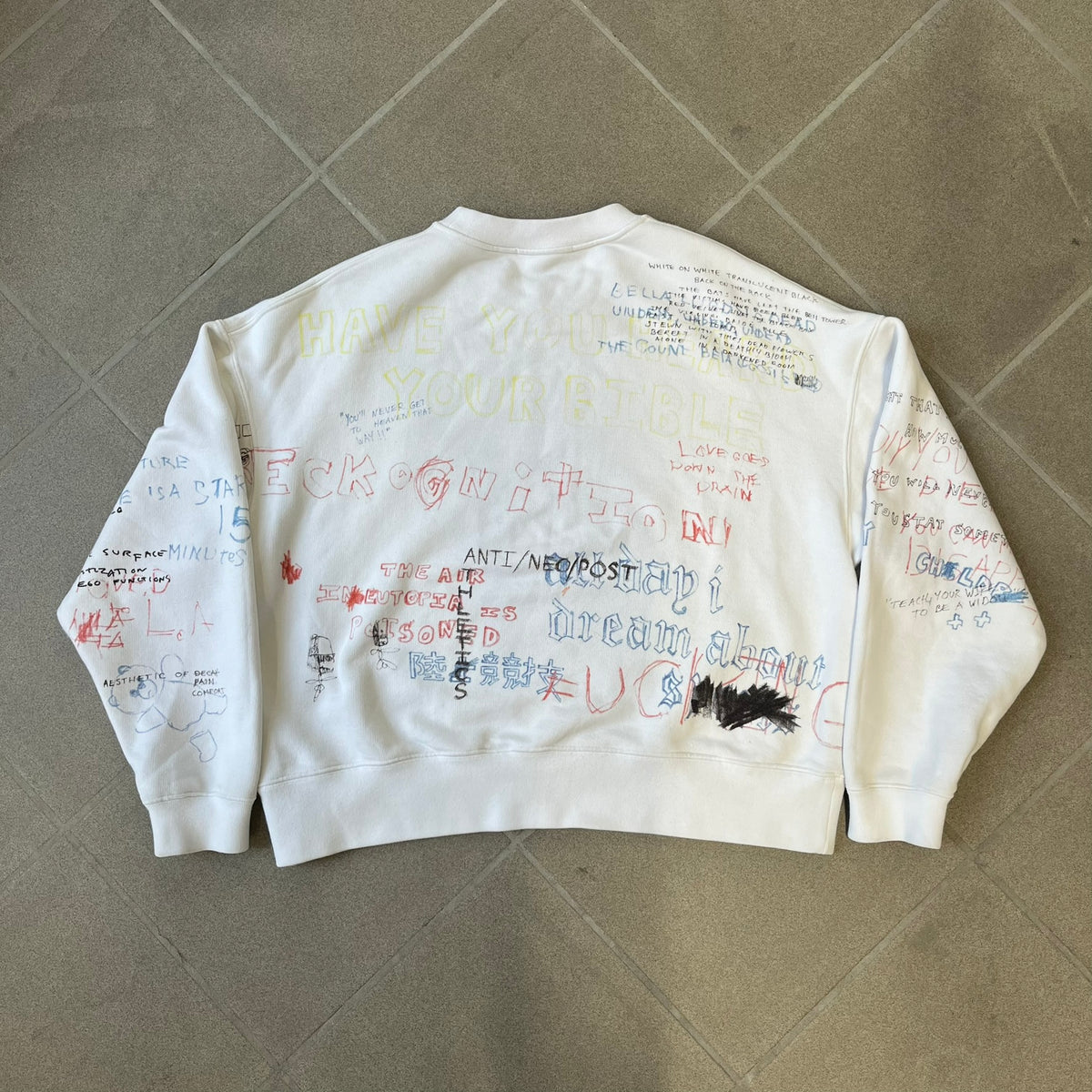 Yeezy Season 5 Scribbled Adidas Crewneck by ERD features an oversized, boxy silhouette in the Arctic colorway. The 100% cotton Adidas crewneck has handwritten-style printed graphics and phrases across the garment, including a embroidered Adidas Three Stripes logo on the chest. It was made in Italy and designed by Henri Alexander Levy from Enfants Riches Déprimés.