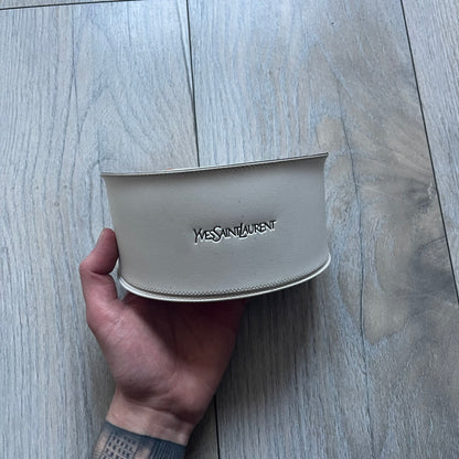 The Yves Saint Laurent 2007 Swirls 6412/S Sunglasses are an oversized model from 2007 with Category 3 sun protection. They feature oversized gradient grey lenses and burgundy (bordeaux) plastic frames, with silver-tone metal swirl details connecting the lenses to the temples. The temples are finished with a metal Yves Saint Laurent logo integrated into the swirl hardware. Made in Italy, with all original markings located on the inside. They come with a white leather YSL case.