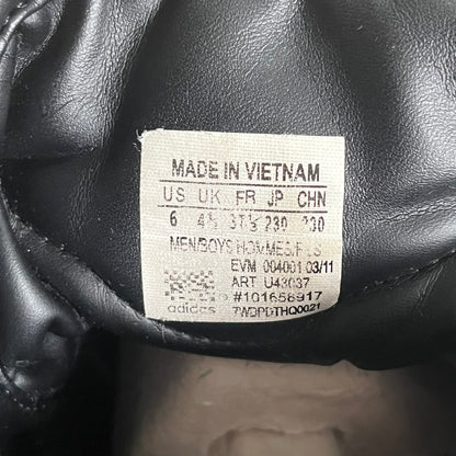 Label on a black leather product indicating 'Made in Vietnam' and other details.