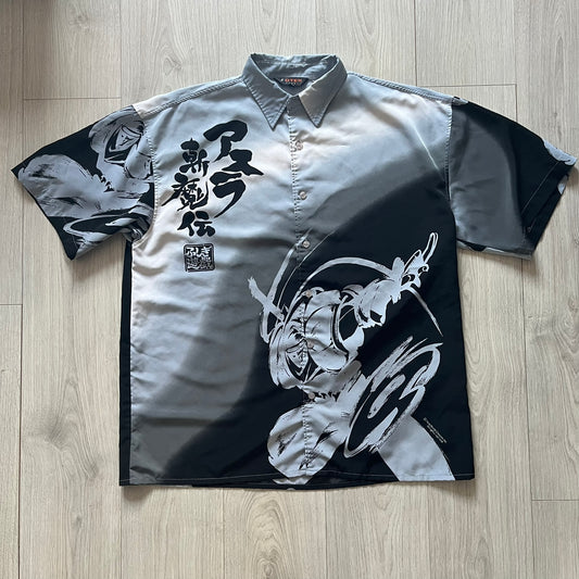 Short-sleeve shirt with black and white designs on a wooden floor