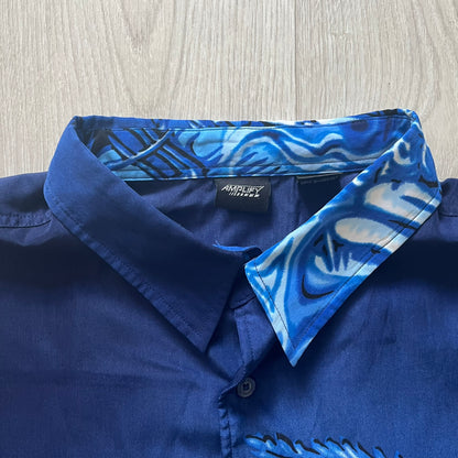 Blue shirt with patterned collar on a wooden surface