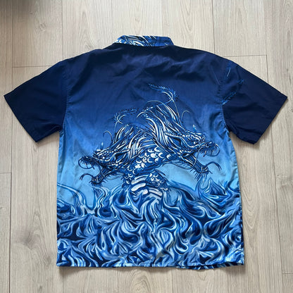 Blue fabric with white dragon design on a wooden surface
