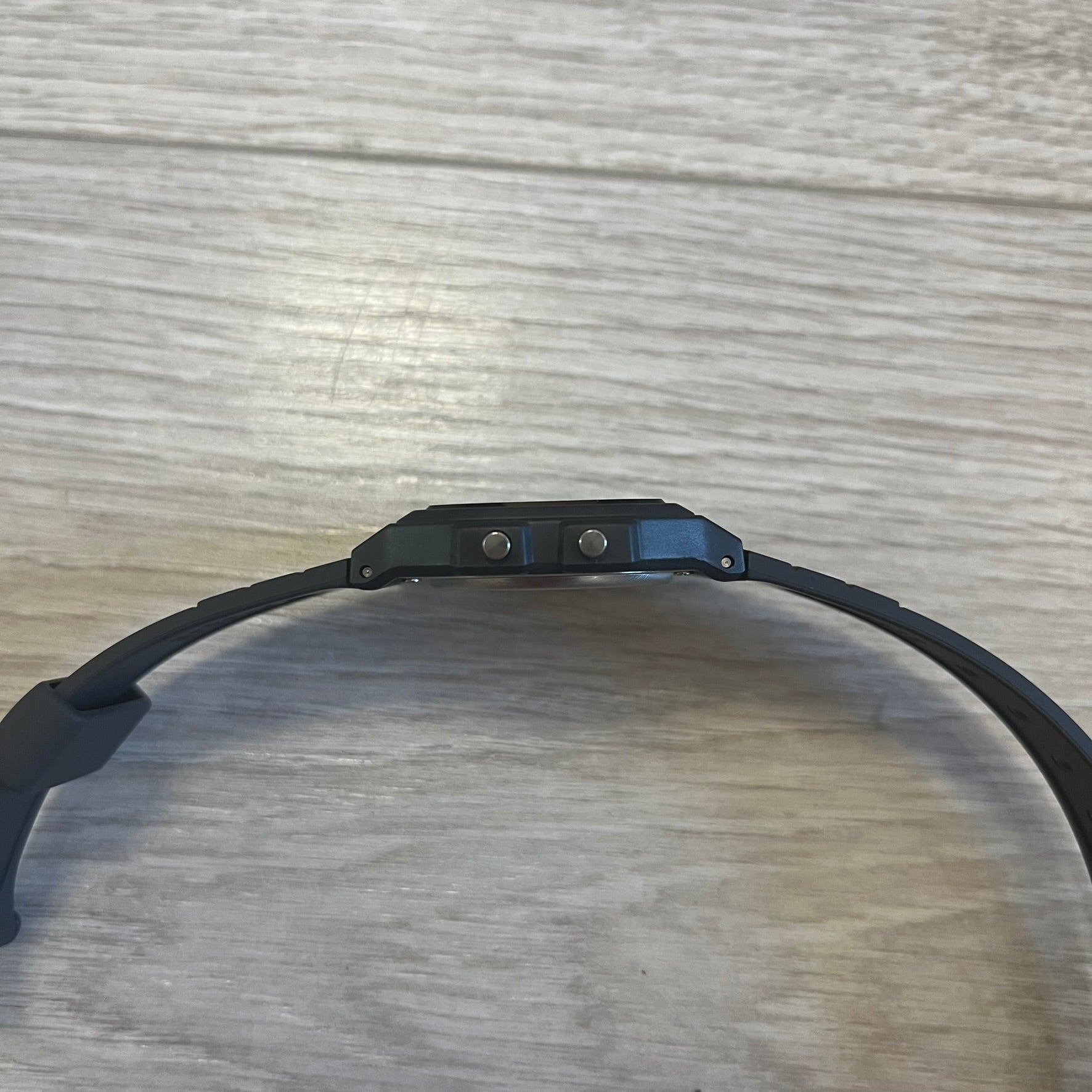 Black electronic device on a wooden surface