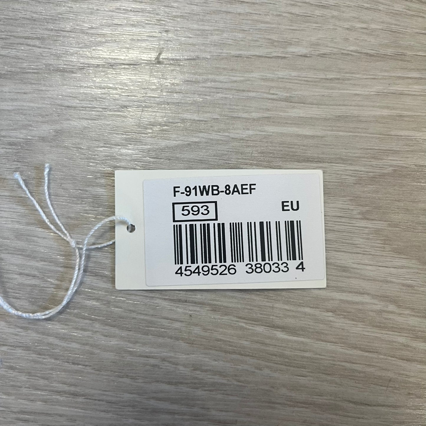 Product tag with barcode and text on a wooden surface