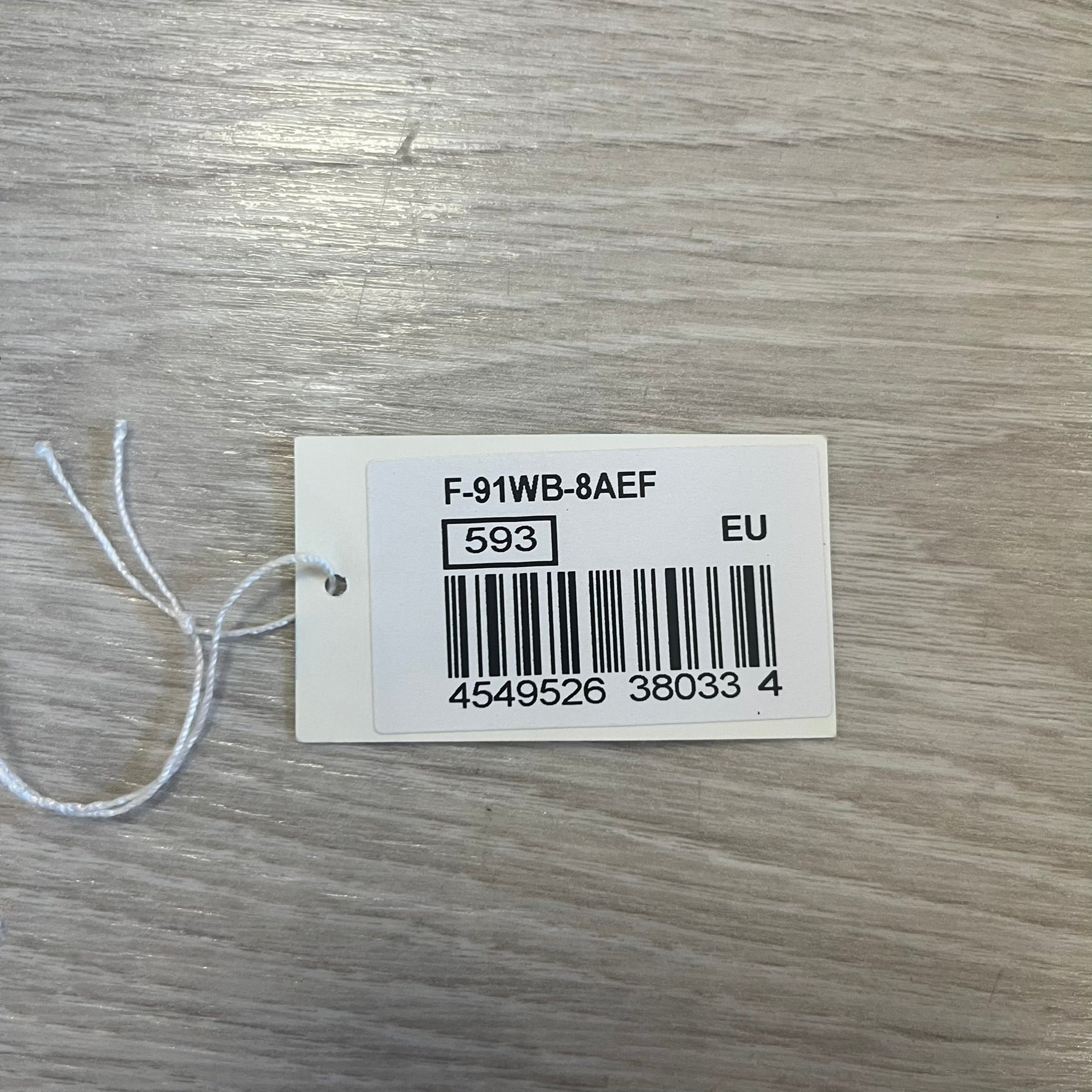 Product tag with barcode and text on a wooden surface