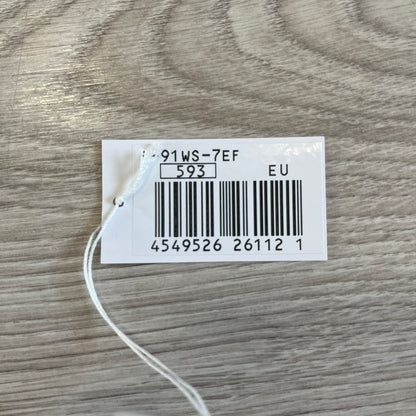 Product tag with barcode and text on a wooden surface