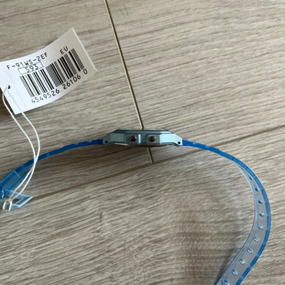 Blue plastic strip with metal component on a wooden surface