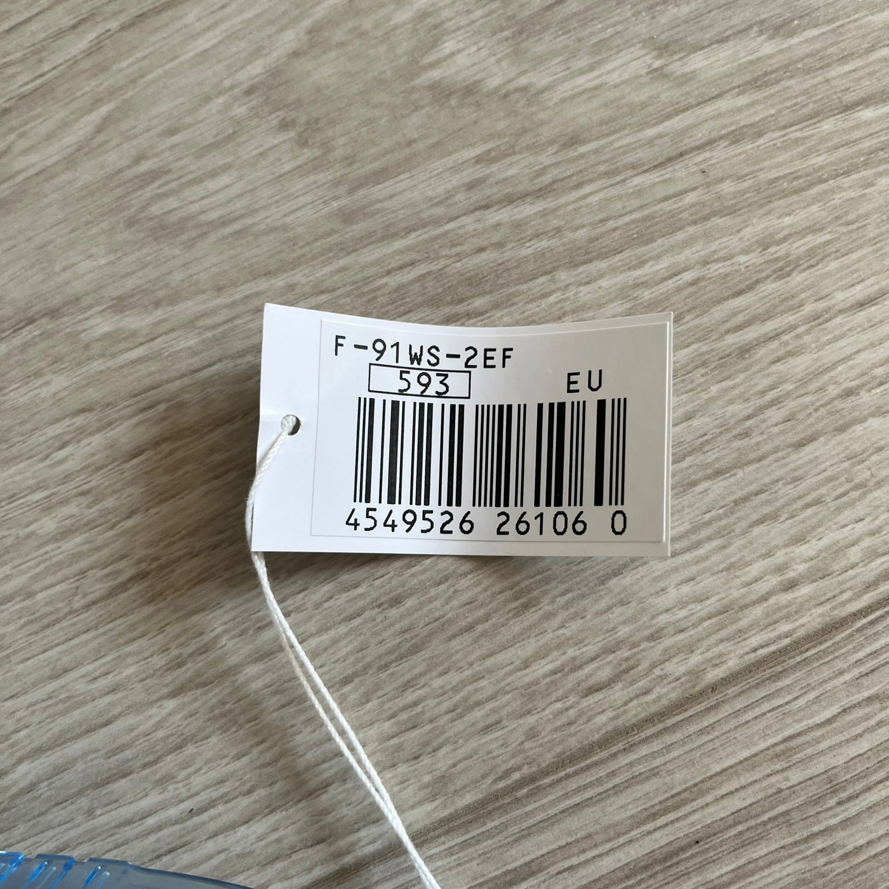 Product tag with a barcode on a wooden surface