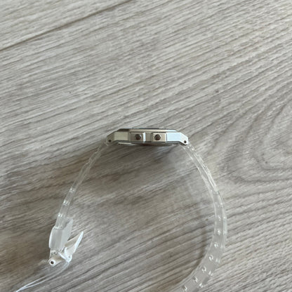 Clear plastic tube with metal fitting on a wooden surface