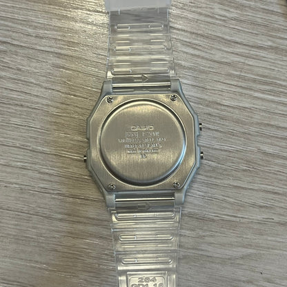 Clear Casio watch on a wooden surface