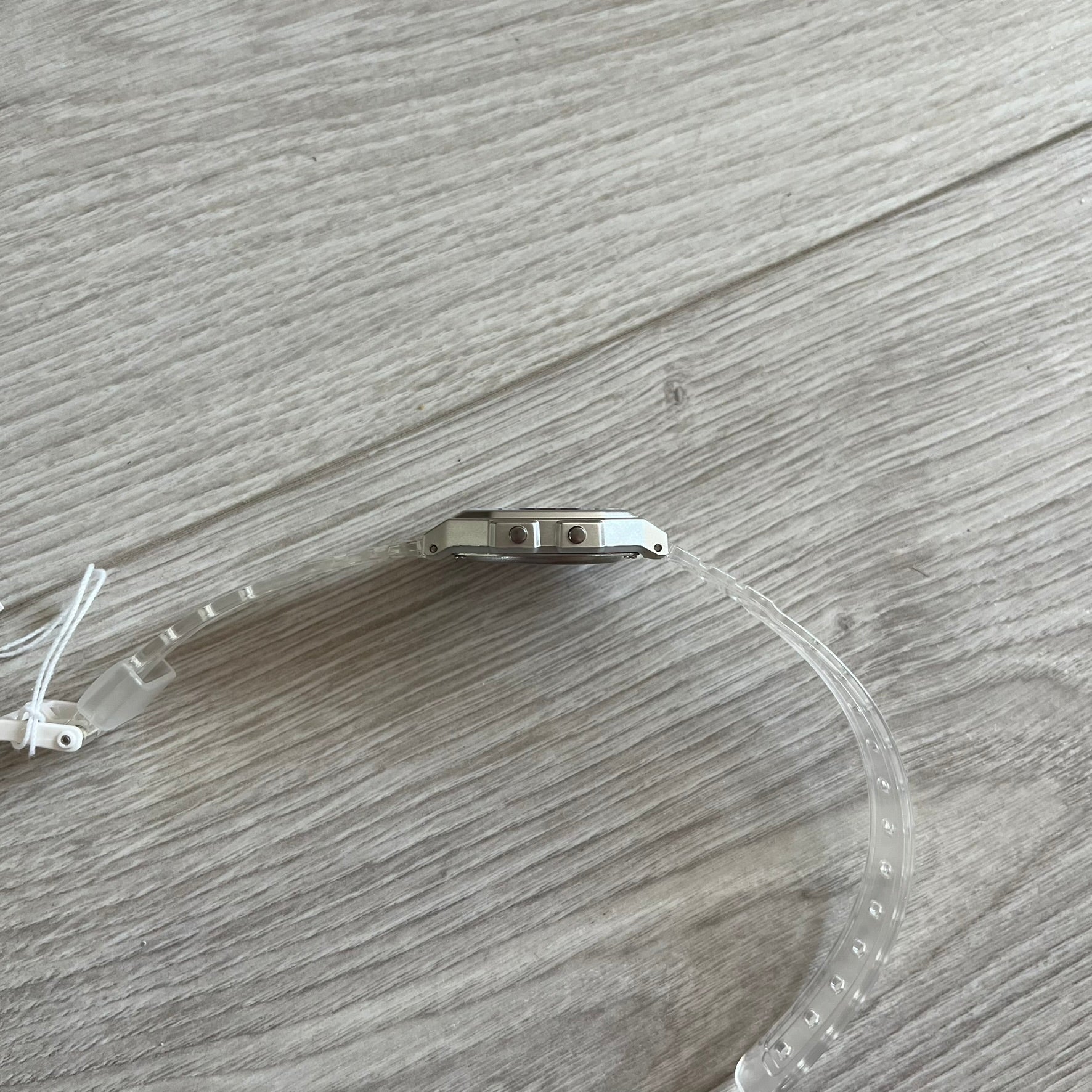 Clear plastic visor with metal bracket on a wooden surface