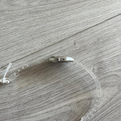 Clear plastic visor with metal bracket on a wooden surface
