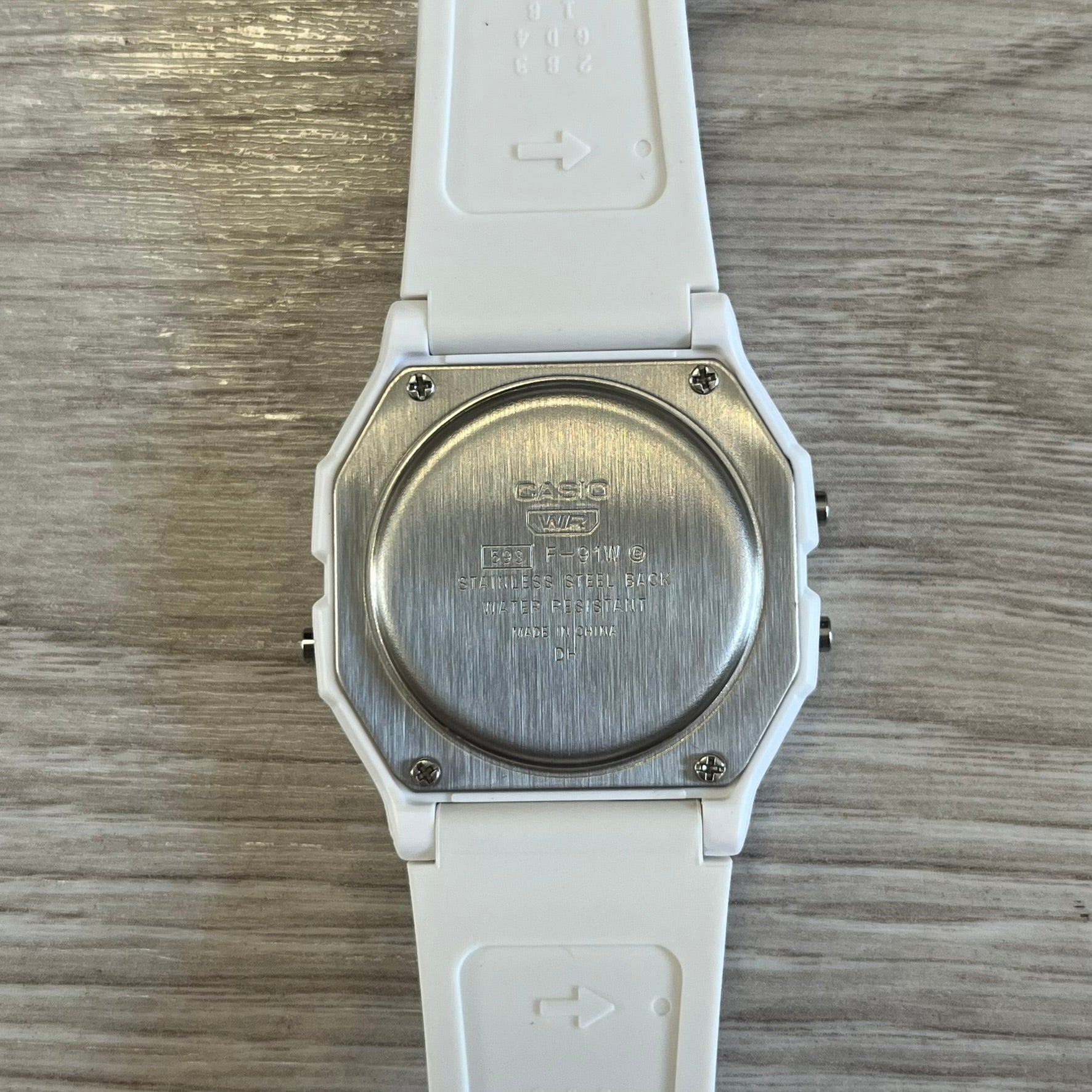 Back view of a Casio watch on a wooden surface