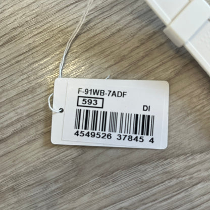 Product tag with barcode and text on a wooden surface