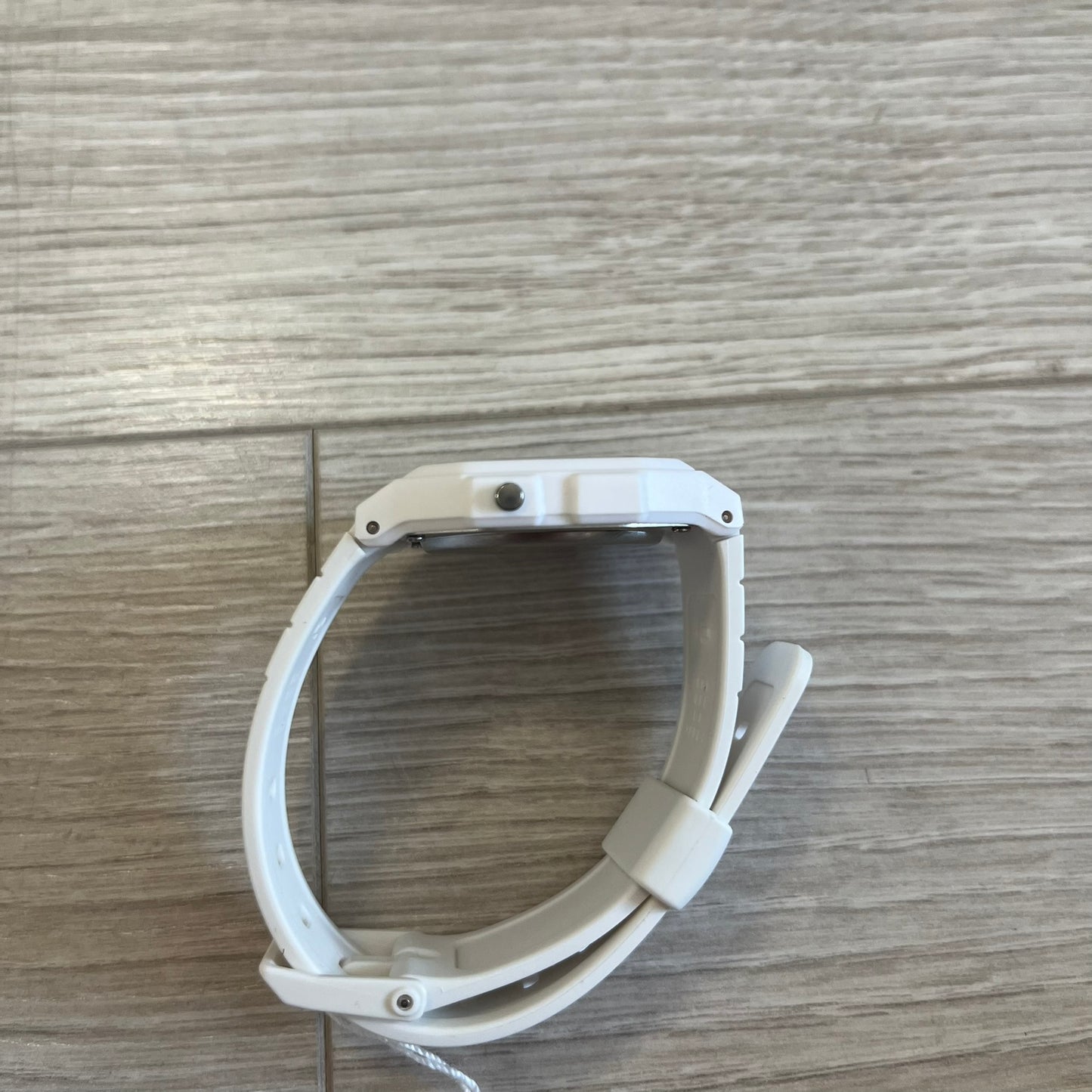 White pet gate on a wooden floor