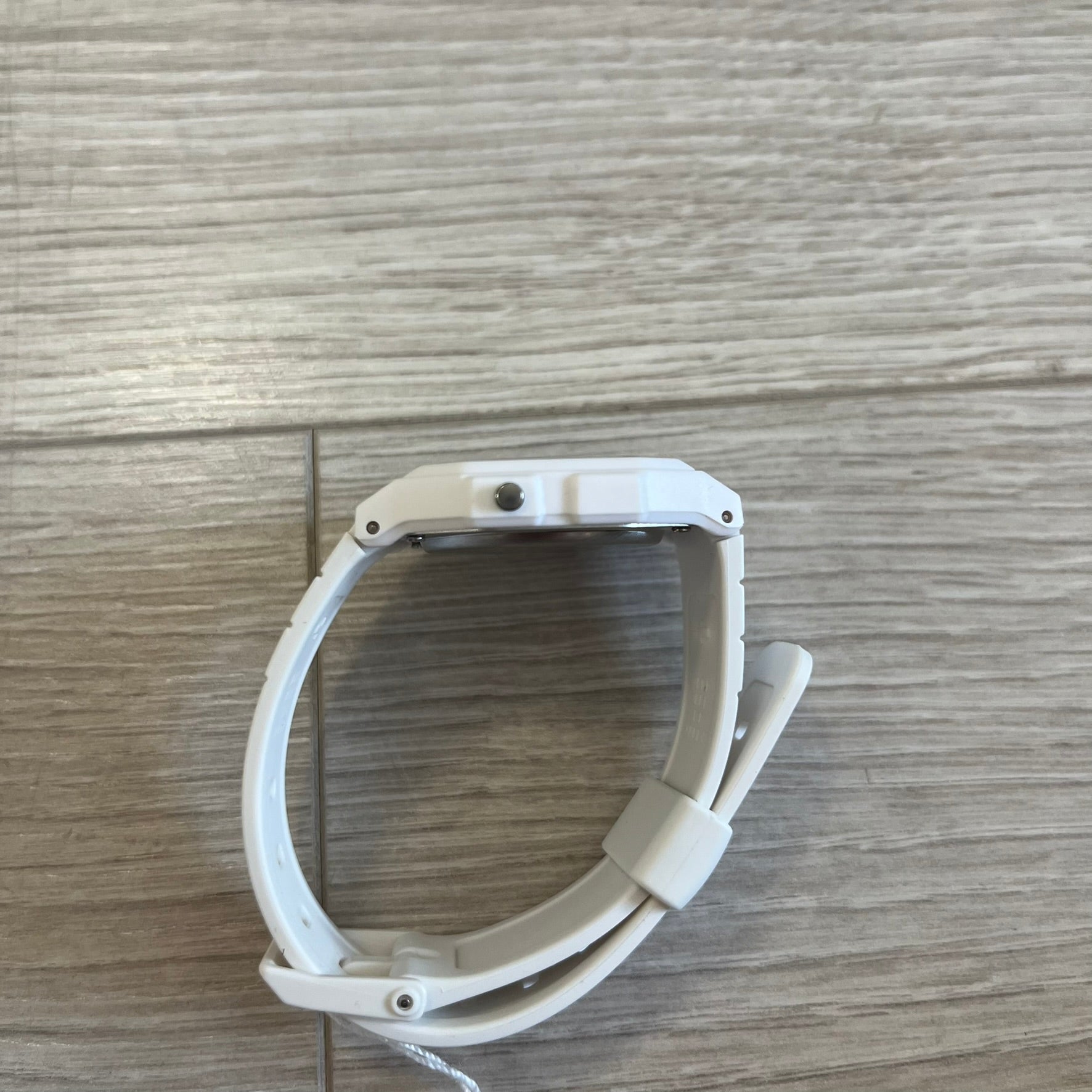 White pet gate on a wooden floor