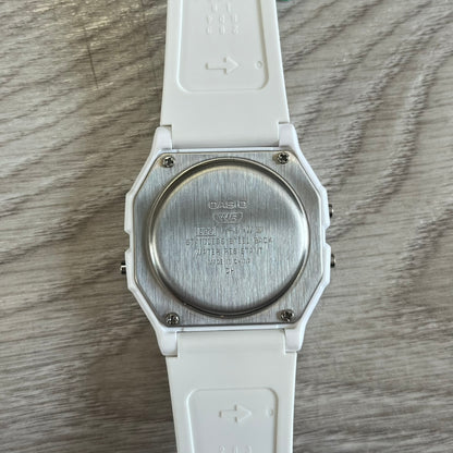 White Casio watch on a wooden surface