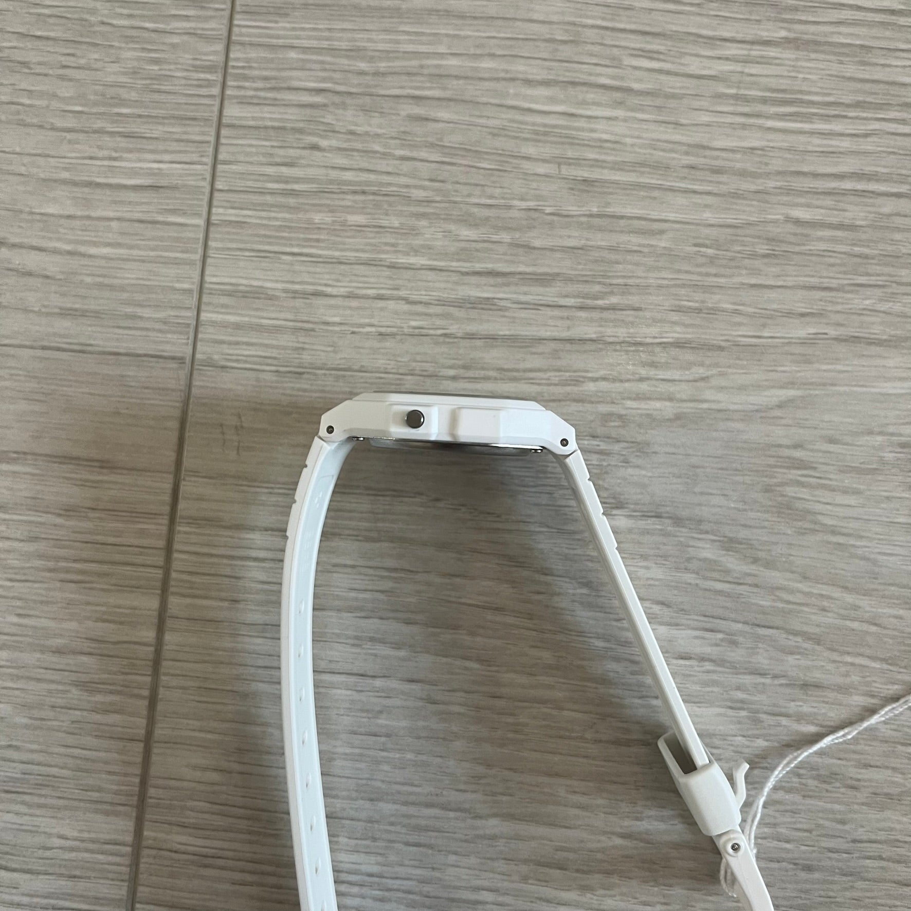 White LED light strip on a wooden floor